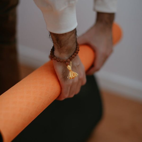 Detail of hands placed on a yoga mat
